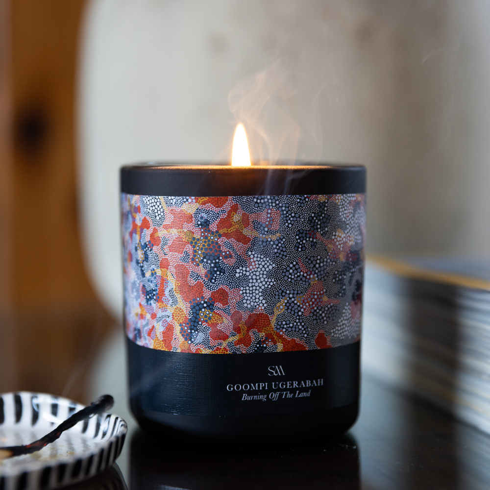 Burning Off The Land Artist Series Candle featuring artwork by Goompi Ugerabah, perfect for gifting