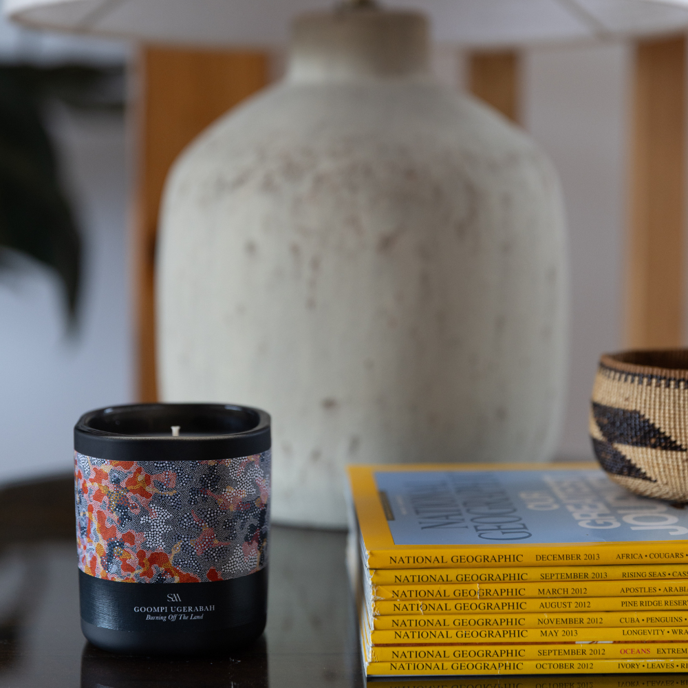 Close-up of Burning Off The Land Candle showing Goompi Ugerabah artwork and textured label