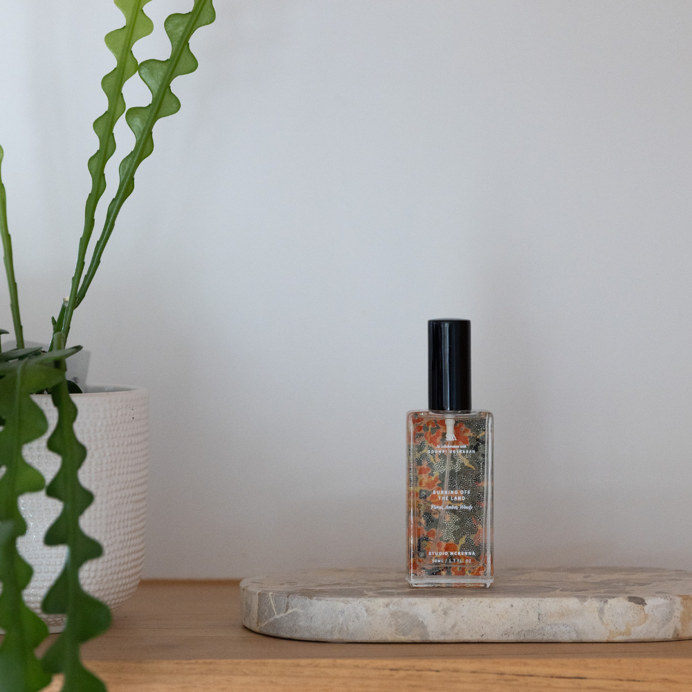 Close-up of Burning Off The Land Interior Spray bottle showing artwork by Goompi Ugerabah inspired by renewal and fire