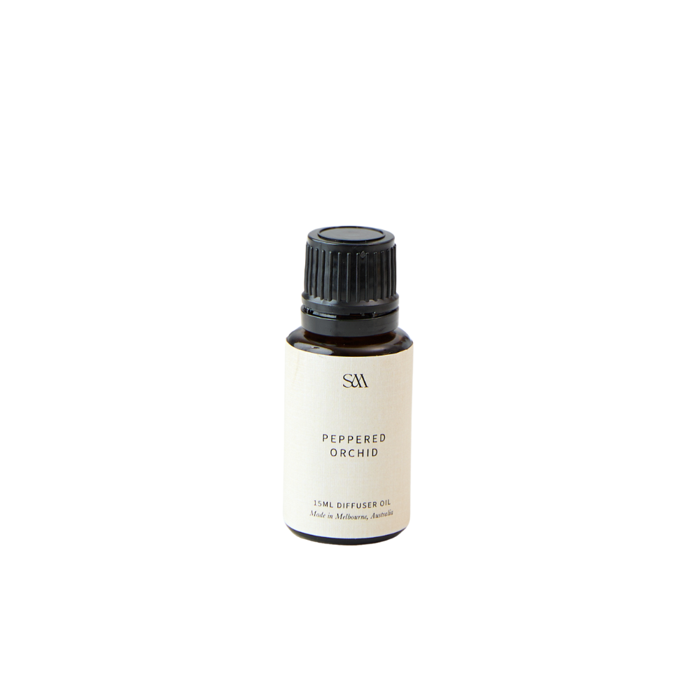 Studio McKenna Peppered Orchid Fragrance Oil in amber glass bottle with minimalist label