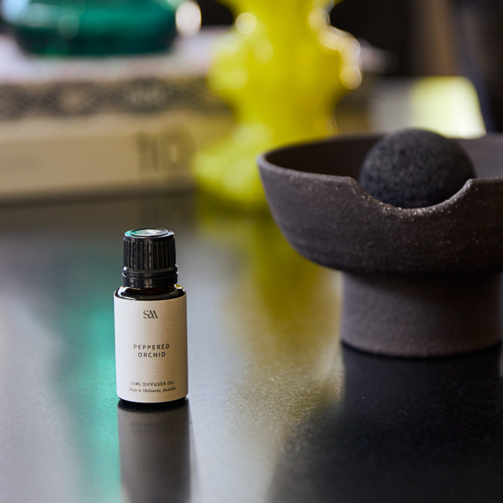 Peppered Orchid Fragrance Oil styled on textured surface with soft lighting