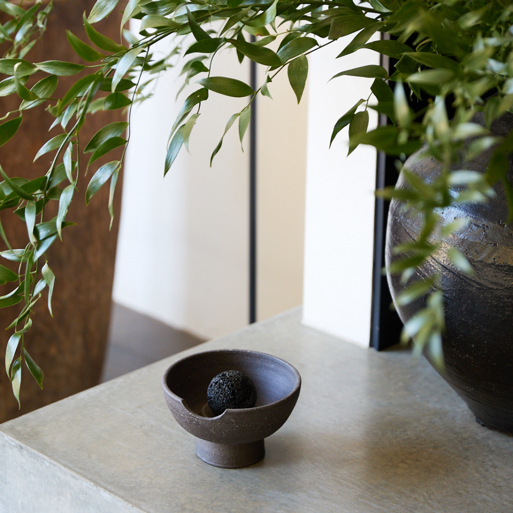 Detail shot of black ceramic tray showing handcrafted texture