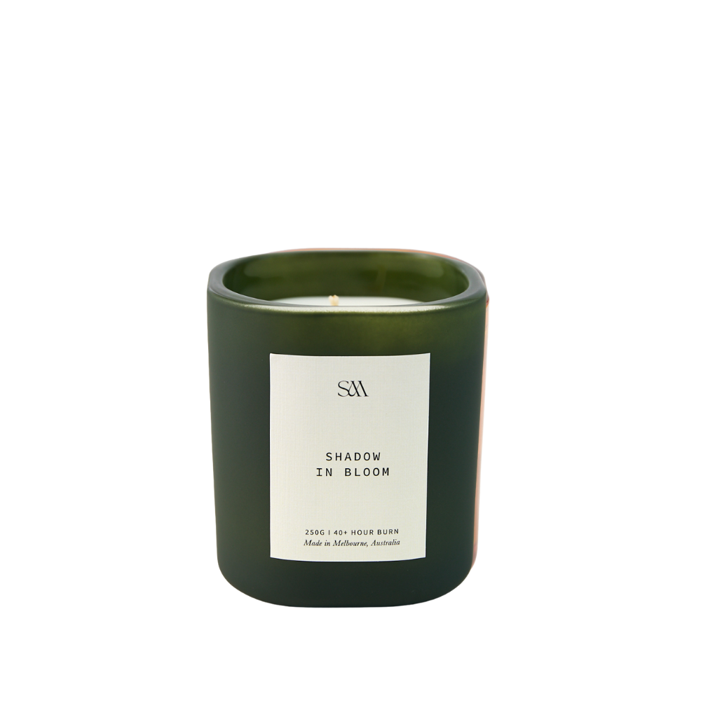 Close-up of Shadow In Bloom Candle showing ceramic vessel and soft wax texture