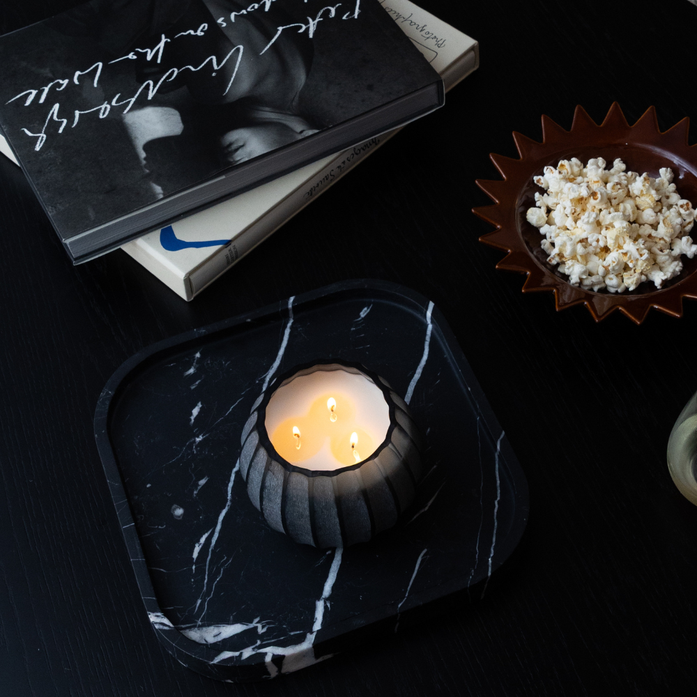 Atolla Blue Bottle Candle burning, releasing Red Santal fragrance in handcrafted blue glass vessel