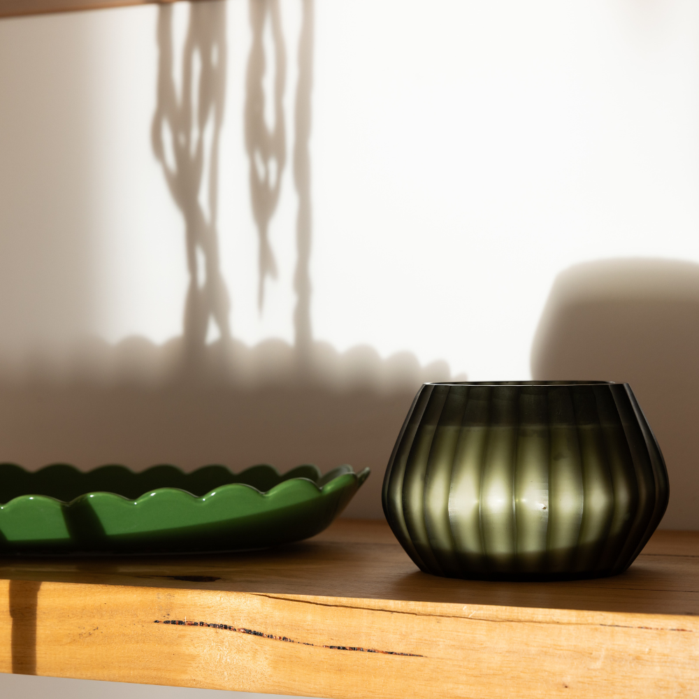 Aura Moss Candle styled in soft light showing hand-carved glass and natural texture