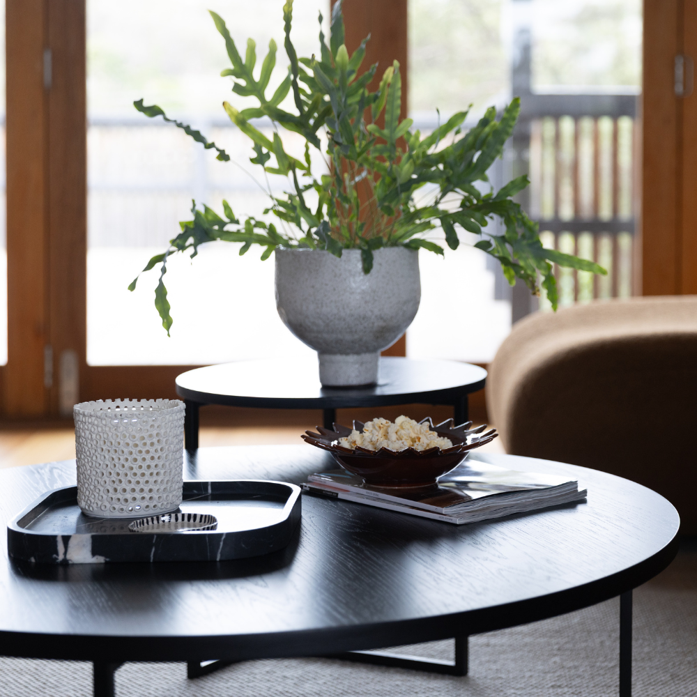 Coralite Ivory Candle burning, releasing Coastal Wilderness fragrance in handcrafted ceramic vessel