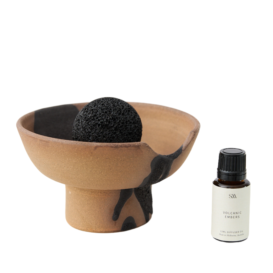 Studio McKenna Volcanic Embers Lahar Diffuser flat lay with ceramic tray, volcanic rock, and fragrance oil bottle