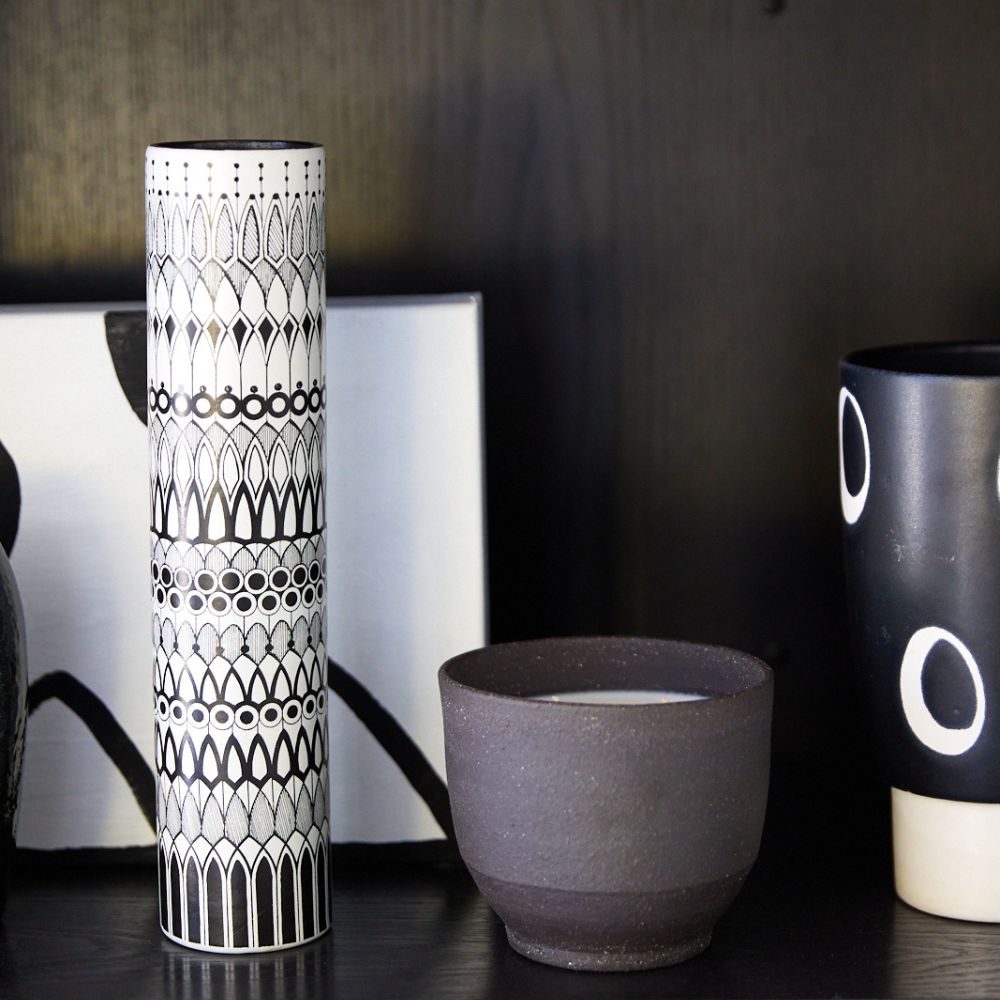 Black ceramic candle styled on shelf