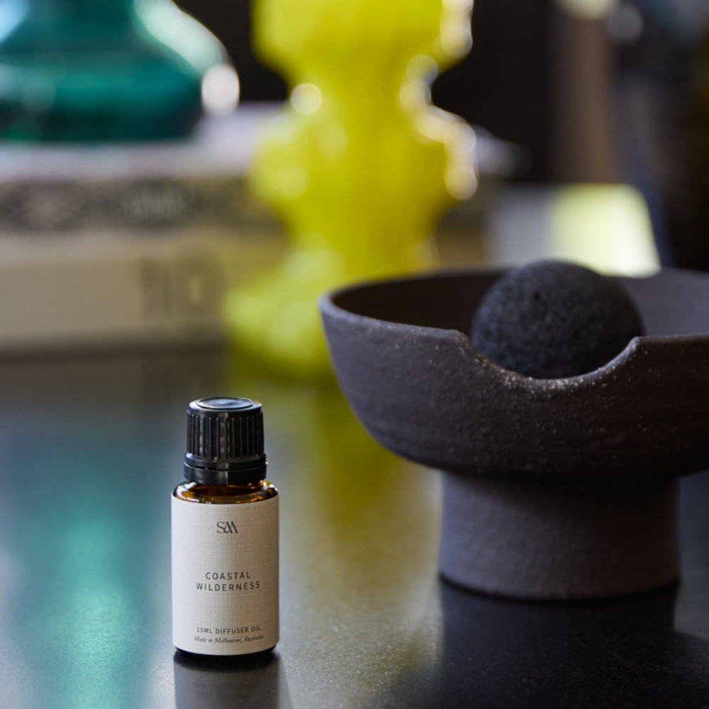 Coastal Wilderness Fragrance Oil styled on textured surface with soft lighting