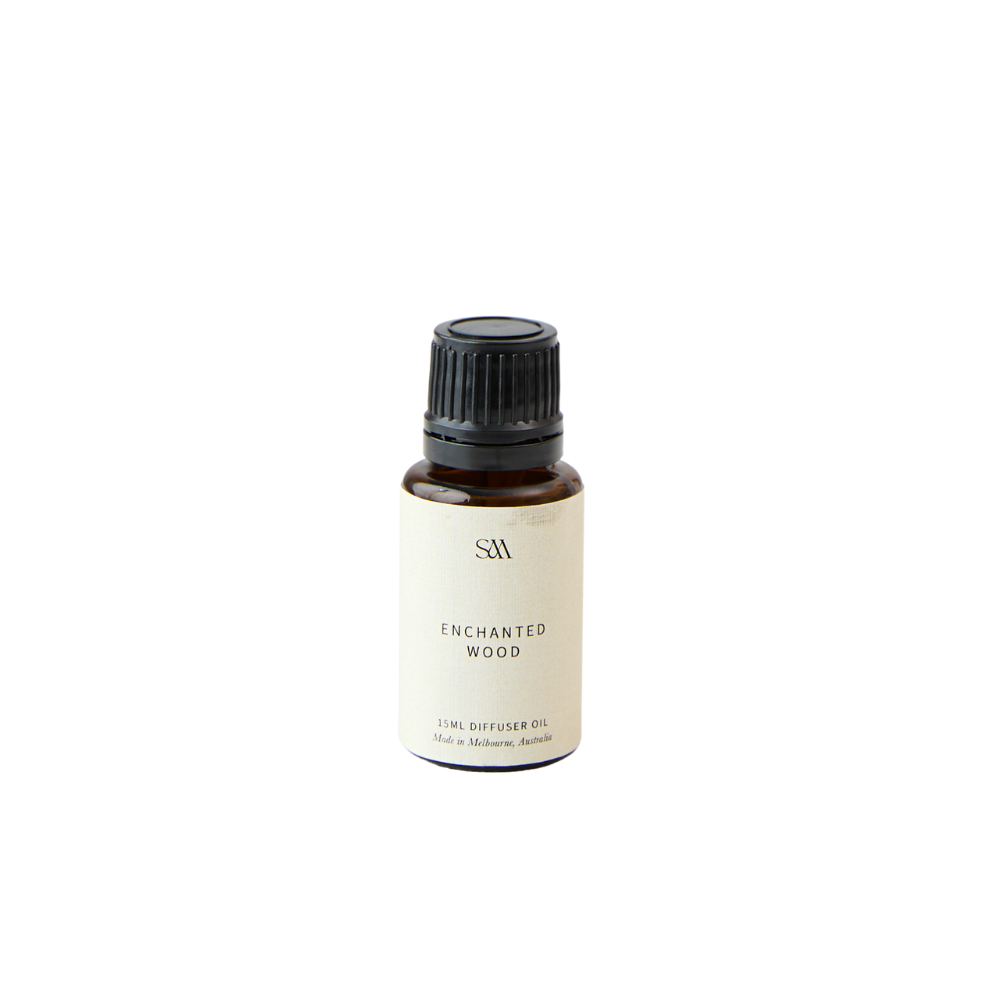 Studio McKenna Enchanted Wood Fragrance Oil in amber glass bottle with minimalist label