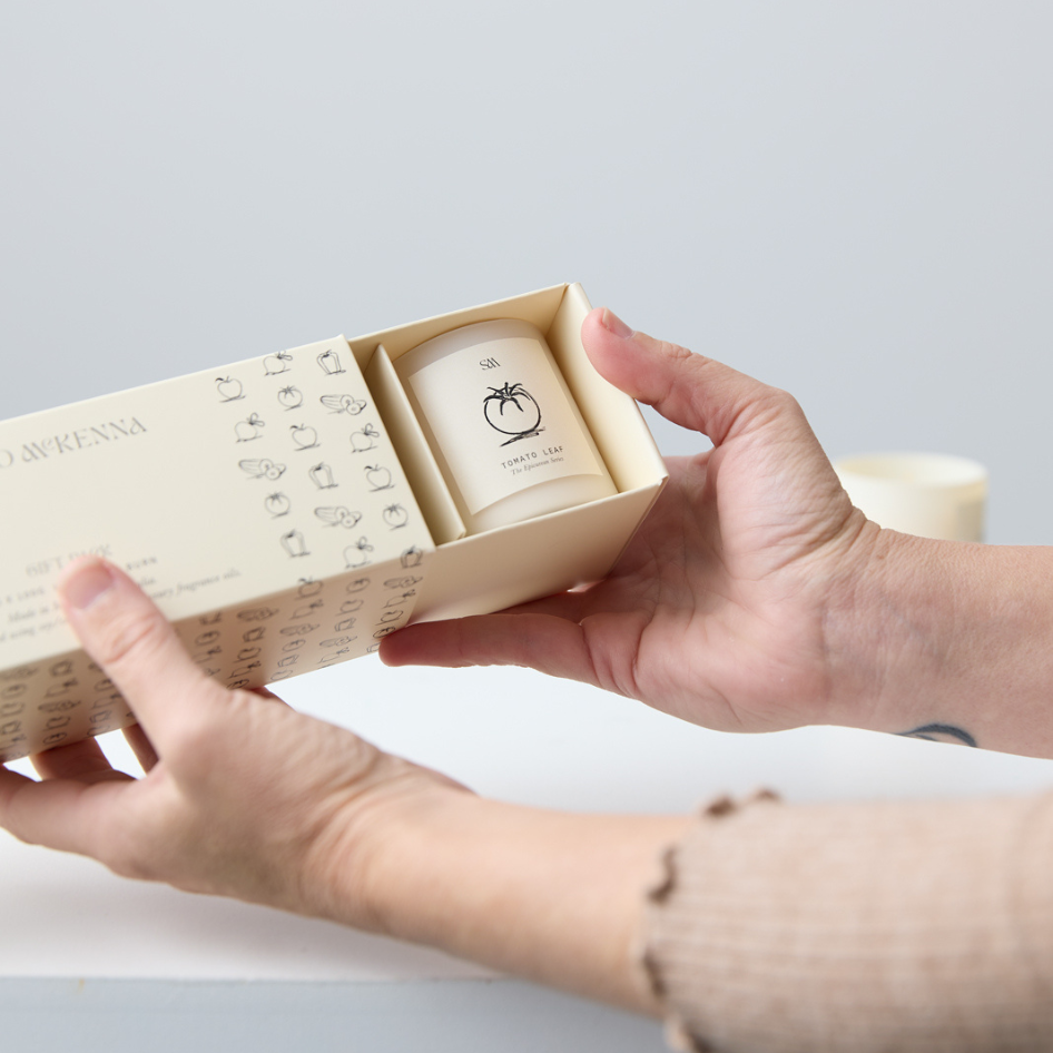 Three Epicurean Series candles styled in a box in natural light