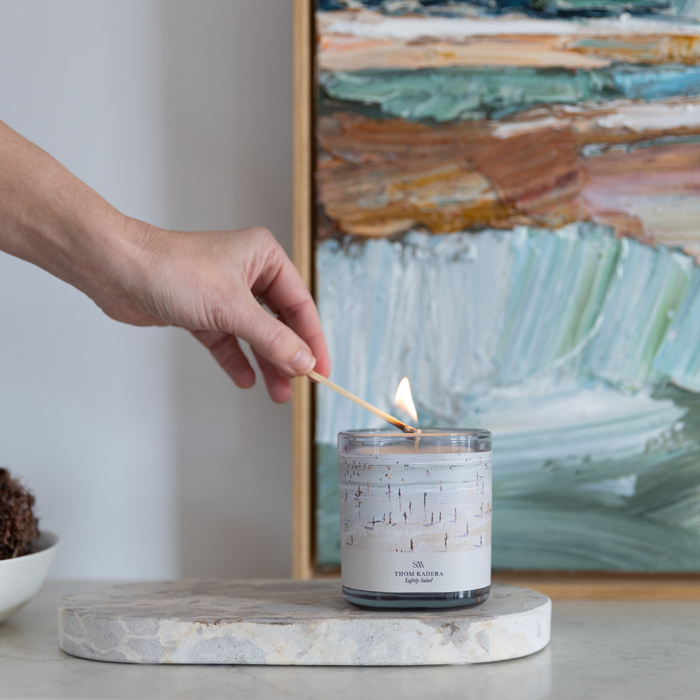Lightly Salted Artist Series Candle burning, releasing soft coastal fragrance