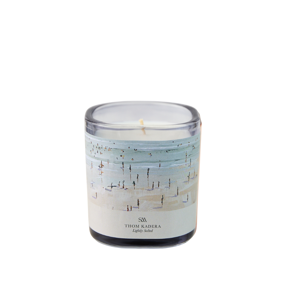 Close-up of Lightly Salted Candle showing Thom Kadera artwork label and glass vessel texture