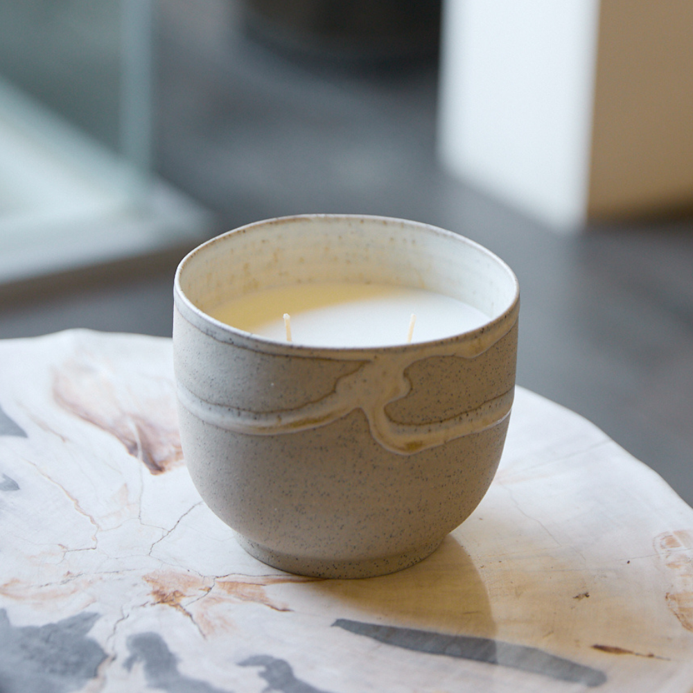Studio McKenna Lunara Candle placed on a natural stone table — ceramic candle for modern interiors