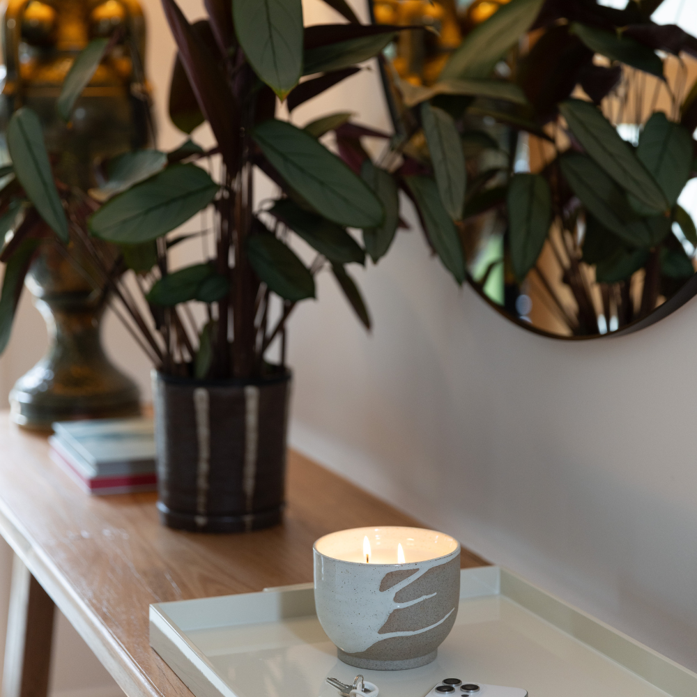 Studio McKenna Lunara Candle placed on a natural stone table — ceramic candle for modern interiors