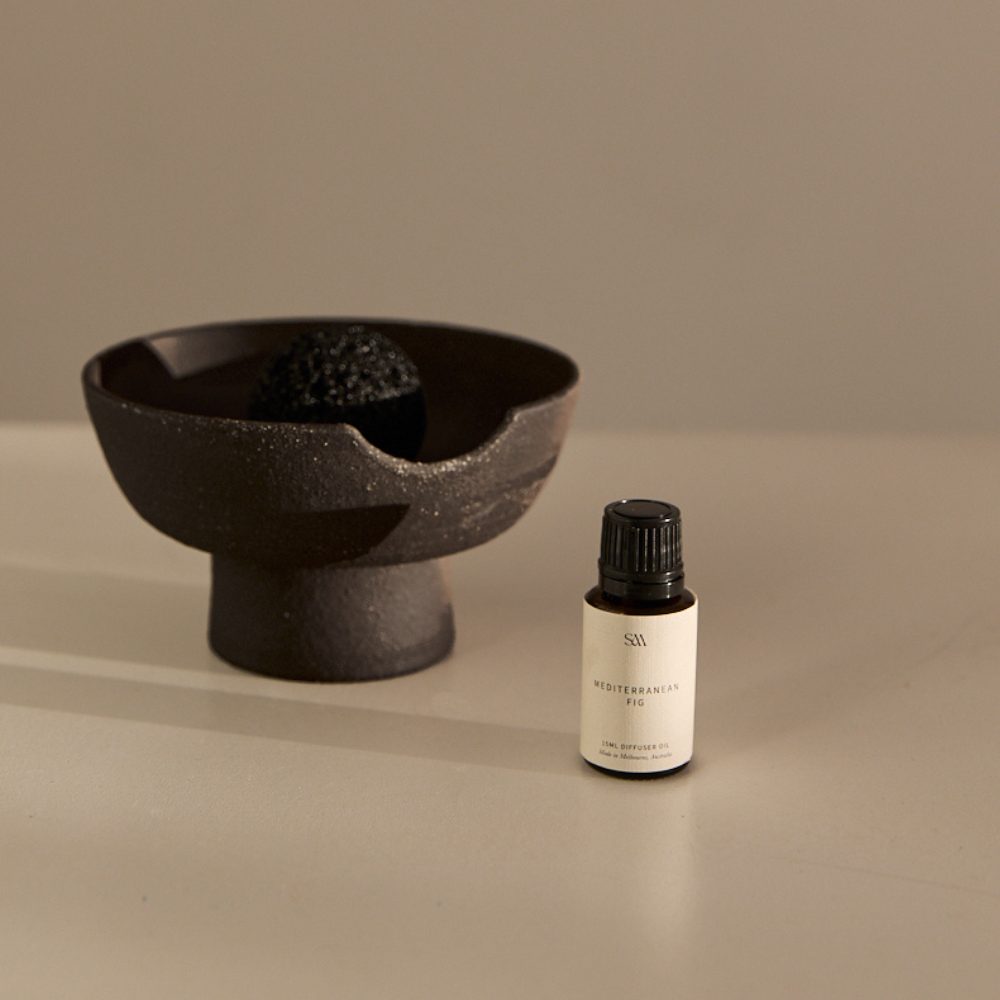 Mediterranean Fig Obsidian Fragrance Oil styled on textured surface with soft lighting