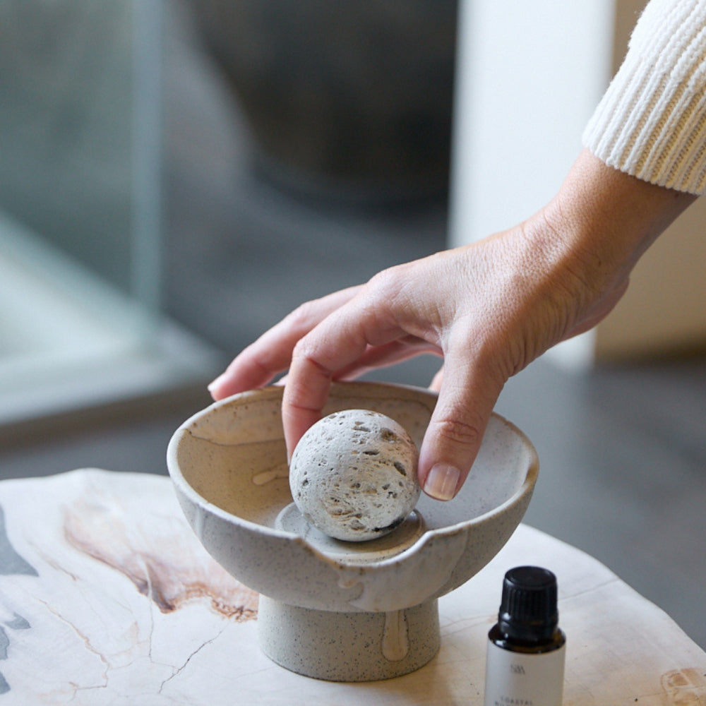 Pumice Stone Ball placed on Studio McKenna ceramic diffuser tray