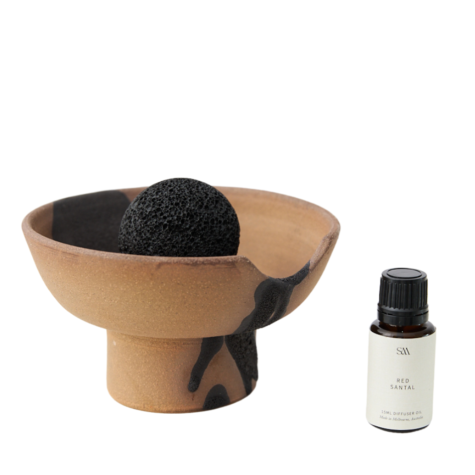 Studio McKenna Red Santal Lahar Scented Diffuser flat lay with ceramic tray, volcanic rock, and fragrance oil bottle