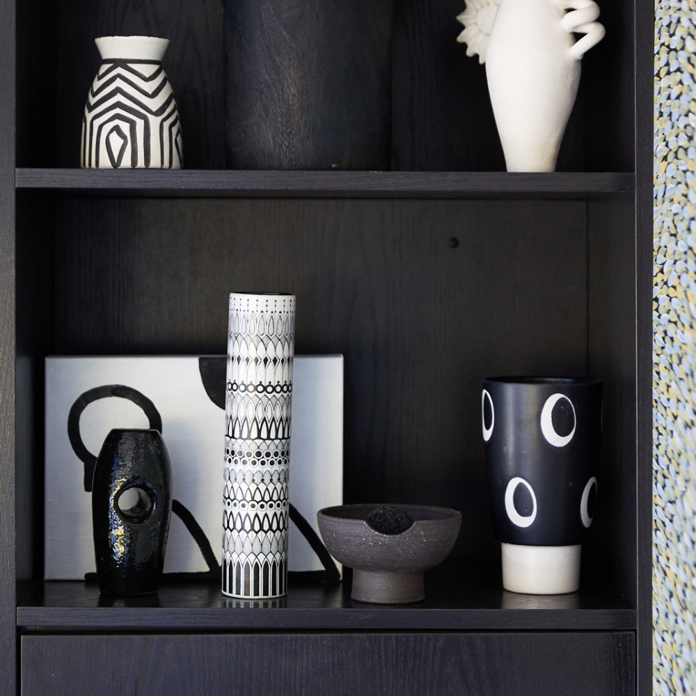 Close-up of volcanic rock resting on handcrafted black ceramic diffuser tray