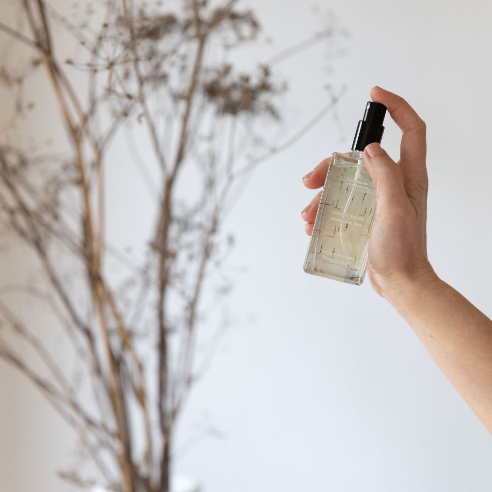 Close-up of Lightly Salted Interior Spray bottle showing detailed artwork by Thom Kadera