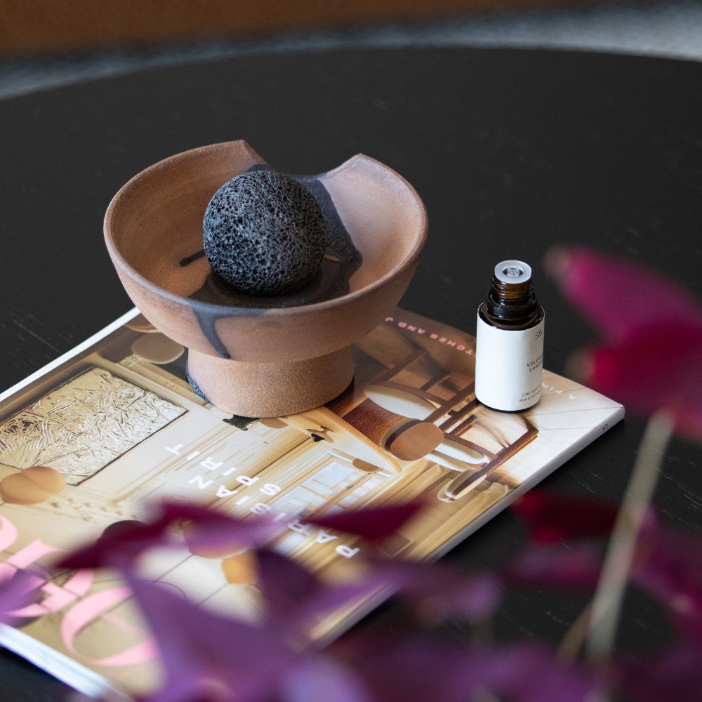 Volcanic Rock Ball placed on handcrafted ceramic diffuser tray