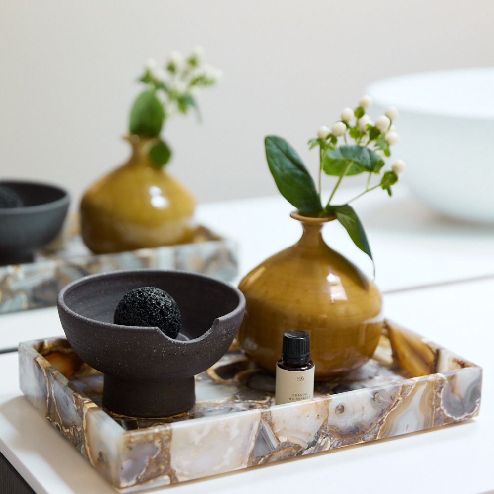 Close-up of volcanic rock resting on handcrafted black ceramic diffuser tray